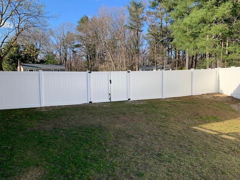 White vinyl privacy fence around a backyard