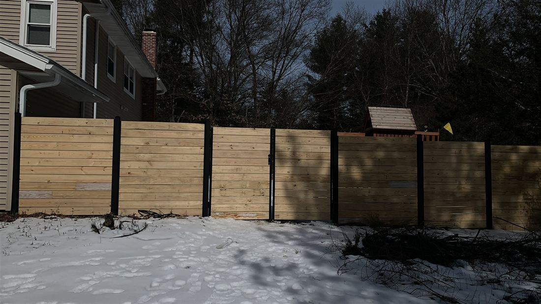 Modern horizontal wood fence with black posts
